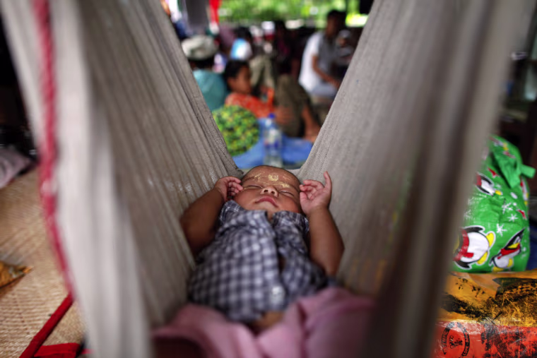 HIV-positive Ei Ei Phyu, who lives at the hospice with his HIV-positive mother, sleeps in a hammock at the HIV/AIDS hospice founded by a member of the National League for Democracy (NLD) party in the suburbs of Yangon on May 26.