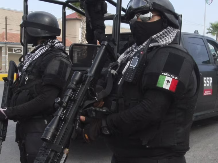 Rapid response Coahuila state police stand at a checkpoint iin Piedras Negras, Mexico, after a prison break on Sept. 18. Security is among the challenges facing the country.
