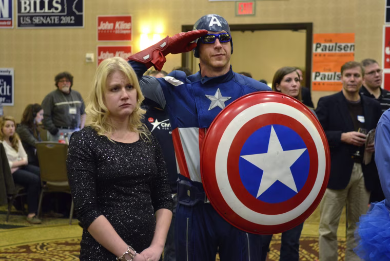 Jon Angell, dressed as Captain America, salutes as Republican presidential candidate Mitt Romney concedes to re-elected U.S. President Barack Obama at the Minnesota Republican election headquarters in Bloomington, Minn., Nov. 6.