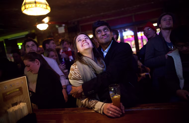 A couple reacts to President Barack Obama being re-elected at The Village Pour House in New York City, Nov. 6.