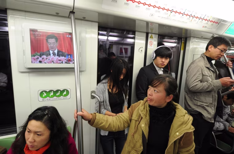 Chinese President Hu Jintao is seen speaking at the opening of the 18th Communist Party Congress on a television in a subway train in Shanghai on Nov. 8.