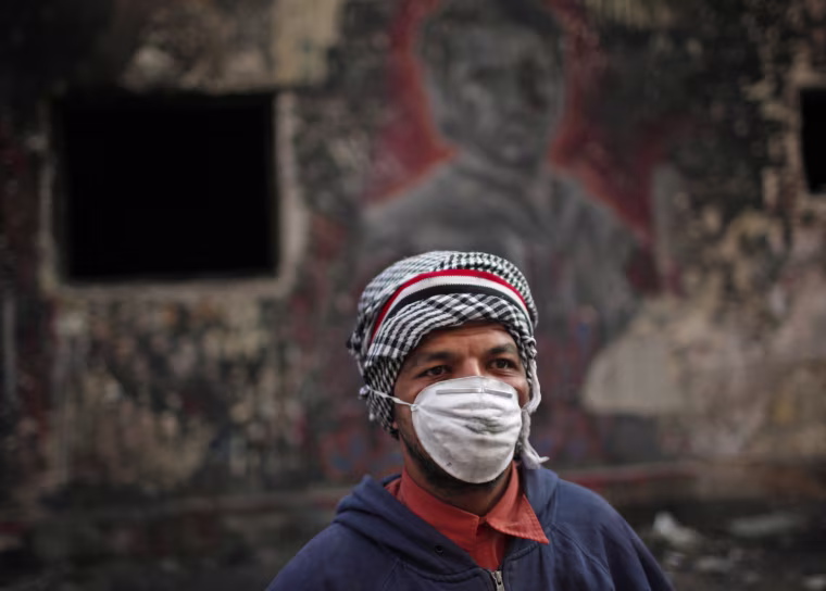 A masked protester during clashes with police in Tahrir Square on Nov. 26.