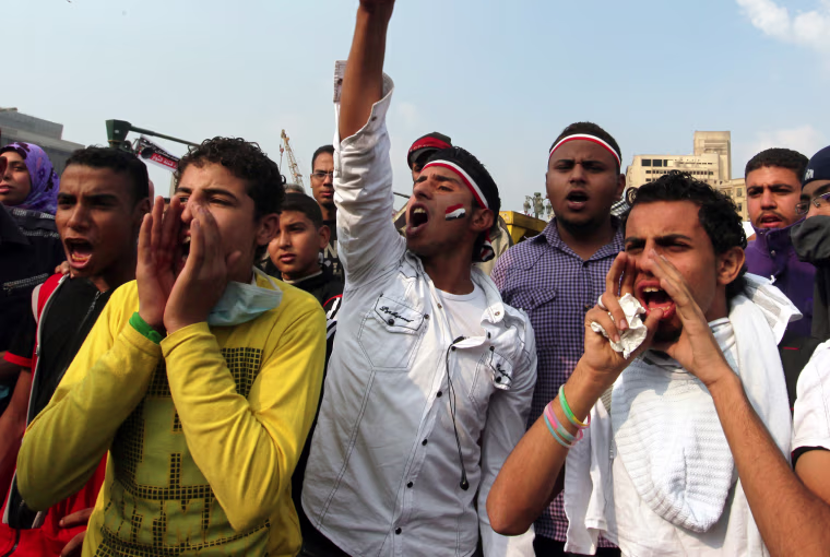 Egyptian protesters shout slogans against President Mohammed Morsi, during a rally against his decree, in Tahrir square, Cairo, Nov. 27.