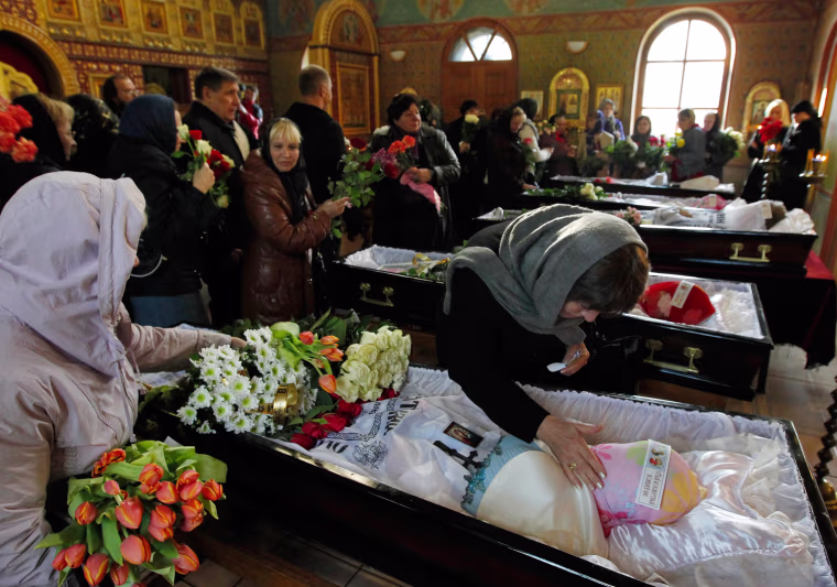 Orphanage teachers and schoolmates attend a mourning church service for car accident victims in Moscow on Sept. 26.