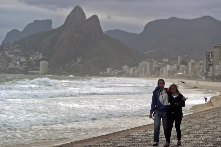 Tourists walk along Ipanema beach in Rio de Janeiro, Brazil on Sept. 26, during a cold day. The temperature lowered to 13 degrees Celcius with a real feel of 9 degrees Celcius.