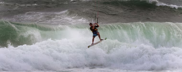 A kite surfer takes advantage of the strong winds at Ipanema beach in Rio de Janeiro, Brazil on Sept. 26, during a cold day.