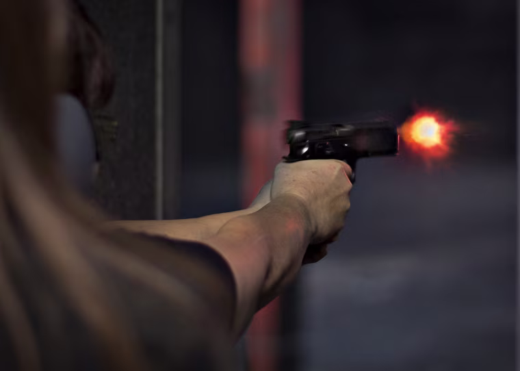 A visitor of DVC Indoor Shooting Centre fires a pistol on their range.