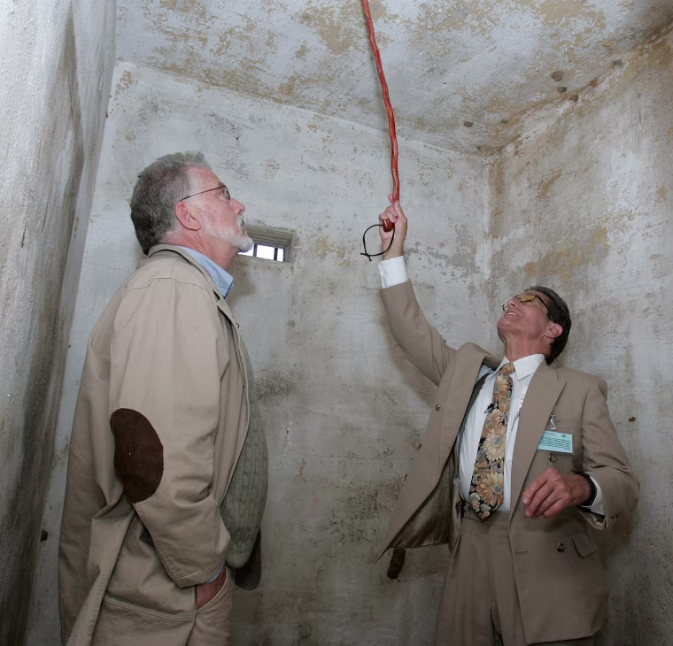 Dick Colon, right, and Mike McCarthy, left, recall their times in one of the white house rooms at the Arthur G. Dozier School for Boys during ceremonies dedicating a memorial to the suffering of the
