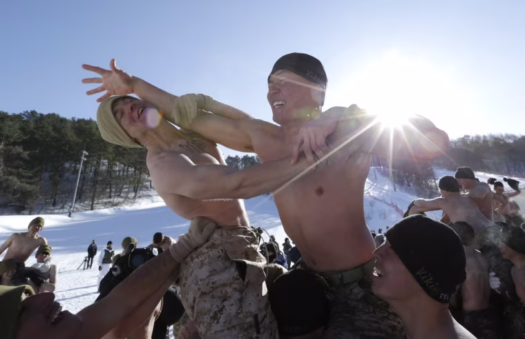 A South Korean Marine, right, and a U.S. Marine, left, take part in a mock cavalry battle during their joint military winter exercise on Feb. 7, 2013.