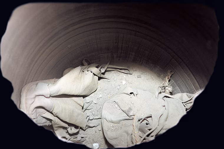 Archaeologists discovered seven shoes, which appear to be made out of bovine, within a jar in an Egyptian temple. The shoes date back more than 2,000 years and this picture shows the inside of the jar before the shoes were removed.