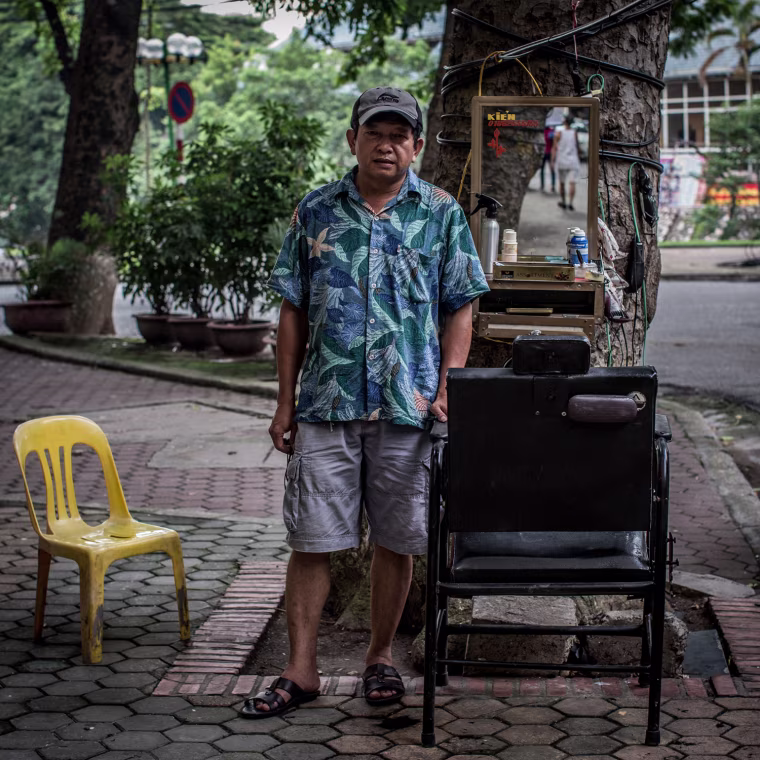 Mr. Kiem, 58, is a retired school teacher and has only been a street barber for the last couple of years.