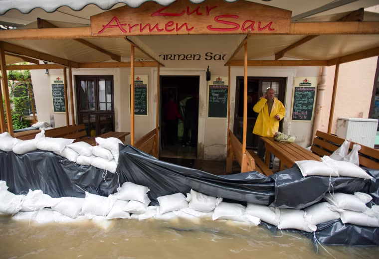 A man makes a call in a restaurant surrounded by the floods of the river Elbe in Pirna, eastern Germany, on June 4. Torrential rain and heavy flooding hit central Europe.