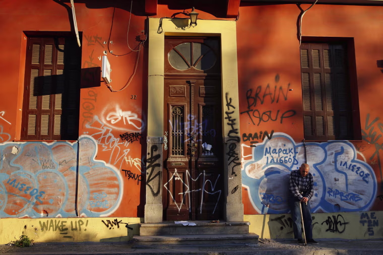 A man waits to receive food outside Klimaka, a charity that works with the homeless, in Athens on Feb. 27, 2013.