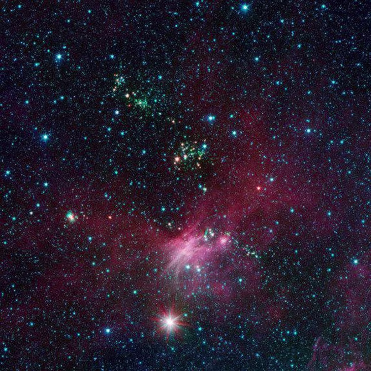 In this view showing a portion of sky near Canis Major, infrared data from NASA's Spitzer Space Telescope are green and blue, while longer-wavelength infrared light from NASA's Wide-field Infrared Survey Explorer (WISE) are red.
