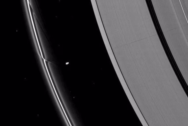 The effects of the small moon Prometheus loom large on two of Saturn's rings in this image taken a short time before Saturn's August 2009 equinox. A long, thin shadow cast by the moon stretches across the A ring on the right. The gravity of potato-shaped Prometheus (86 kilometers, or 53 miles across) periodically creates streamer-channels in the F ring, and the moon's handiwork can seen be on the left of the image.