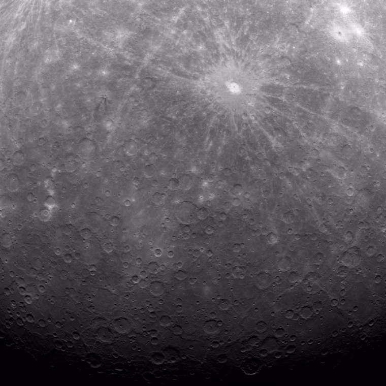 The first image sent back to Earth from Mercury orbit shows a rayed crater known as Debussy and a smaller crater with unusual dark rays, called Matabei. The picture was transmitted to Earth by NASA's Messenger spacecraft.