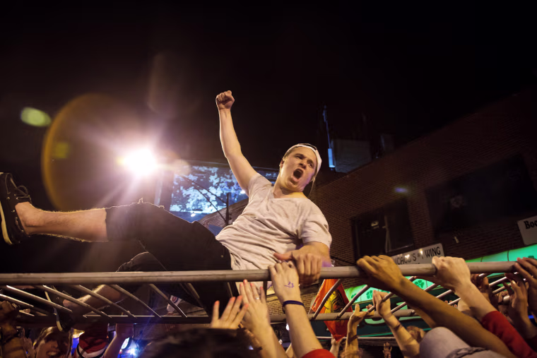 Chicago Blackhawks fans celebrate the win over the Boston Bruins in Game Six of the 2013 NHL Stanley Cup Final on Clark Street on June 25, 2013 in Chicago, Illinois.
