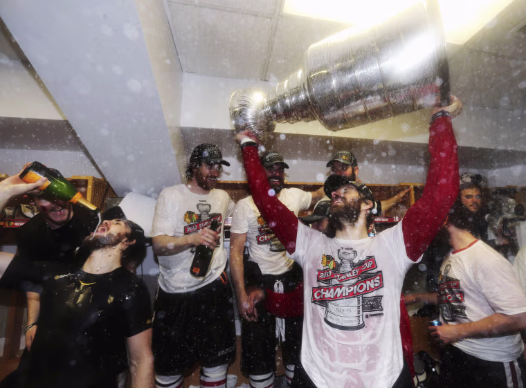 Michal Handzus of the Chicago Blackhawks celebrates with the Stanley Cup in the locker room after his team defeated the Boston Bruins in Game Six of their NHL Stanley Cup Finals hockey series in Boston, Mass., on June 24, 2013.