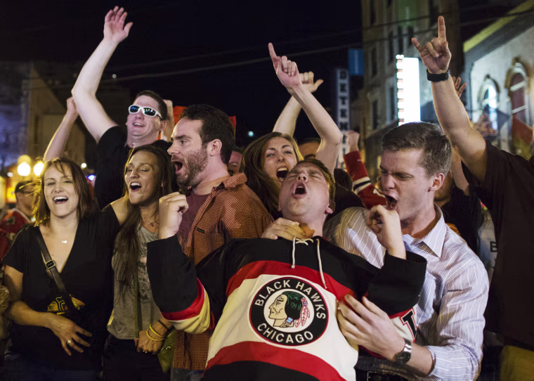 Fans celebrate on West Division Street in Chicago after the Chicago Blackhawks won the NHL hockey Stanley Cup Finals on June 24, 2013. The Blackhawks defeated the Boston Bruins 3-2 in Game 6 to win the championship in Boston.