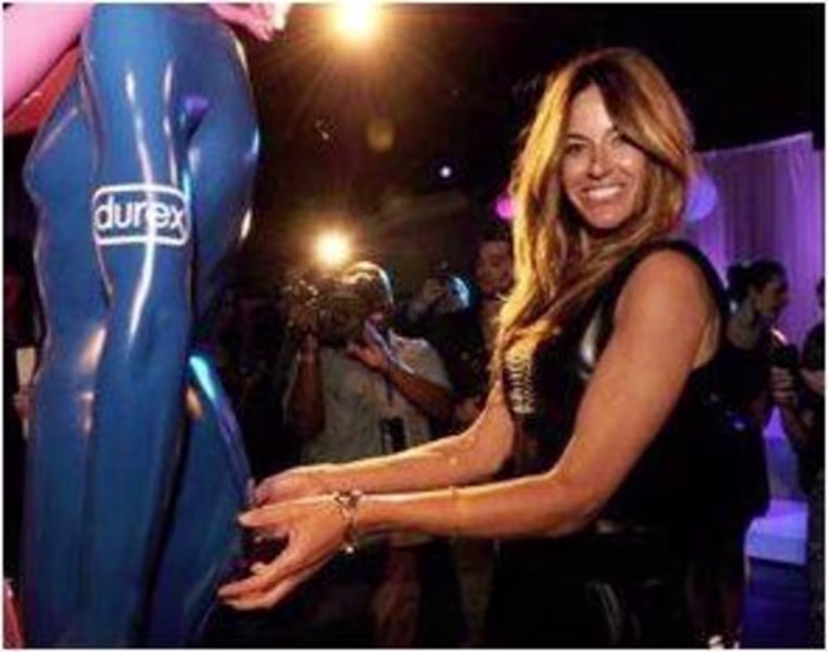 Kelly Bensimon leaving her mark on the his and hers Durex statues. Durex donated money to dance4life for every celeb signature.