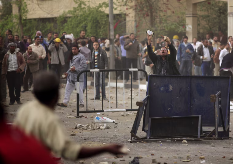 An Egyptian man gestures during clashes between supporters and opponents of Egypt's powerful Muslim Brotherhood near the Islamist group's Cairo headquarters on March 22, 2013.