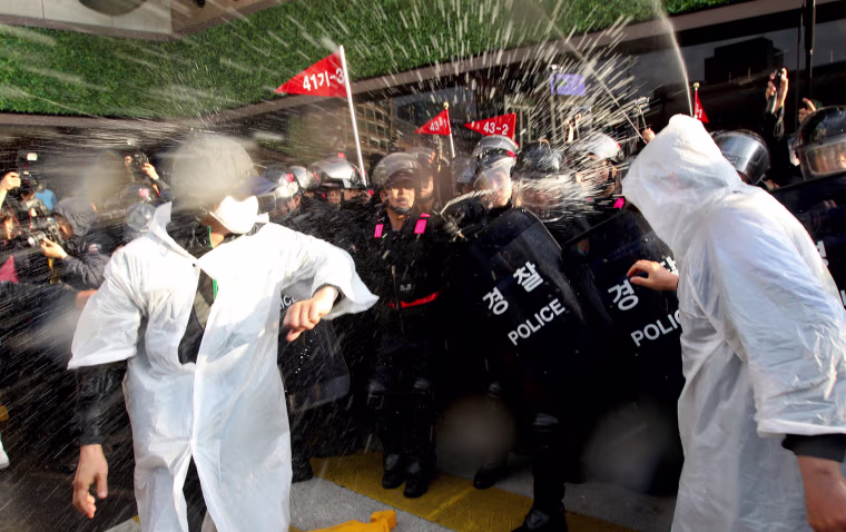 South Korean riot policemen spray tear gas at protesters during a rally marking 123th World Labor Day in Seoul, South Korea on May 1. The protesters attended the demonstration demanding an improvement of working conditions for temporary workers.