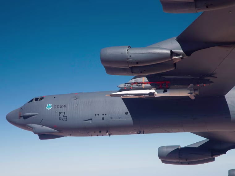 The U.S. Air Force's sleek, light-colored X-51A Waverider hypersonic vehicle can be seen tucked under the wing of a B-52H Stratofortress for this week's test launch.