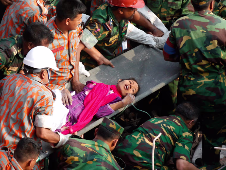 Rescuers pull out a female survivor, Reshma, alive on the 17th day after the Rana Plaza building collapsed, in Savar, Dhaka, Bangladesh, 10 May 2013. Television footage showed troops removing the survivor, identified as Reshma Begum, from the rubble and taking her to an ambulance.