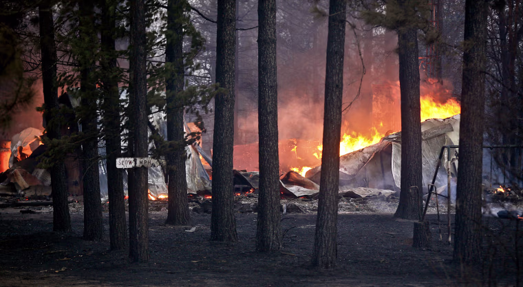 A structure burns along Sutfin Road east of Comminsky Road in Highland Township, Wis., east of Solon Springs, Wis., on May 14. Crews from Wisconsin and Minnesota were trying to control a rapidly growing wildfire in northwestern Wisconsin that forced evacuations of the sparsely populated area. Several structures were destroyed in a mostly rural and wooded area east of Solon Springs as the forest fire grew to 9 square miles, the Wisconsin Department of Natural Resources said. No injuries had been reported.
