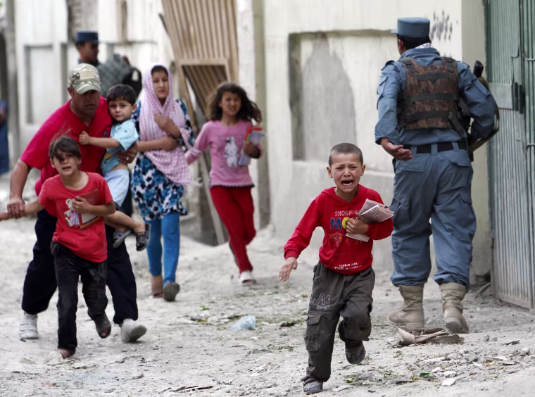 Children run away after an explosion in Kabul on May 24, 2013. Several large explosions rocked a busy area in the center of the Afghan capital, Kabul, on Friday.