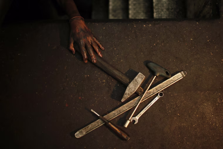 Mohammed Jundeya reaches for a tool.