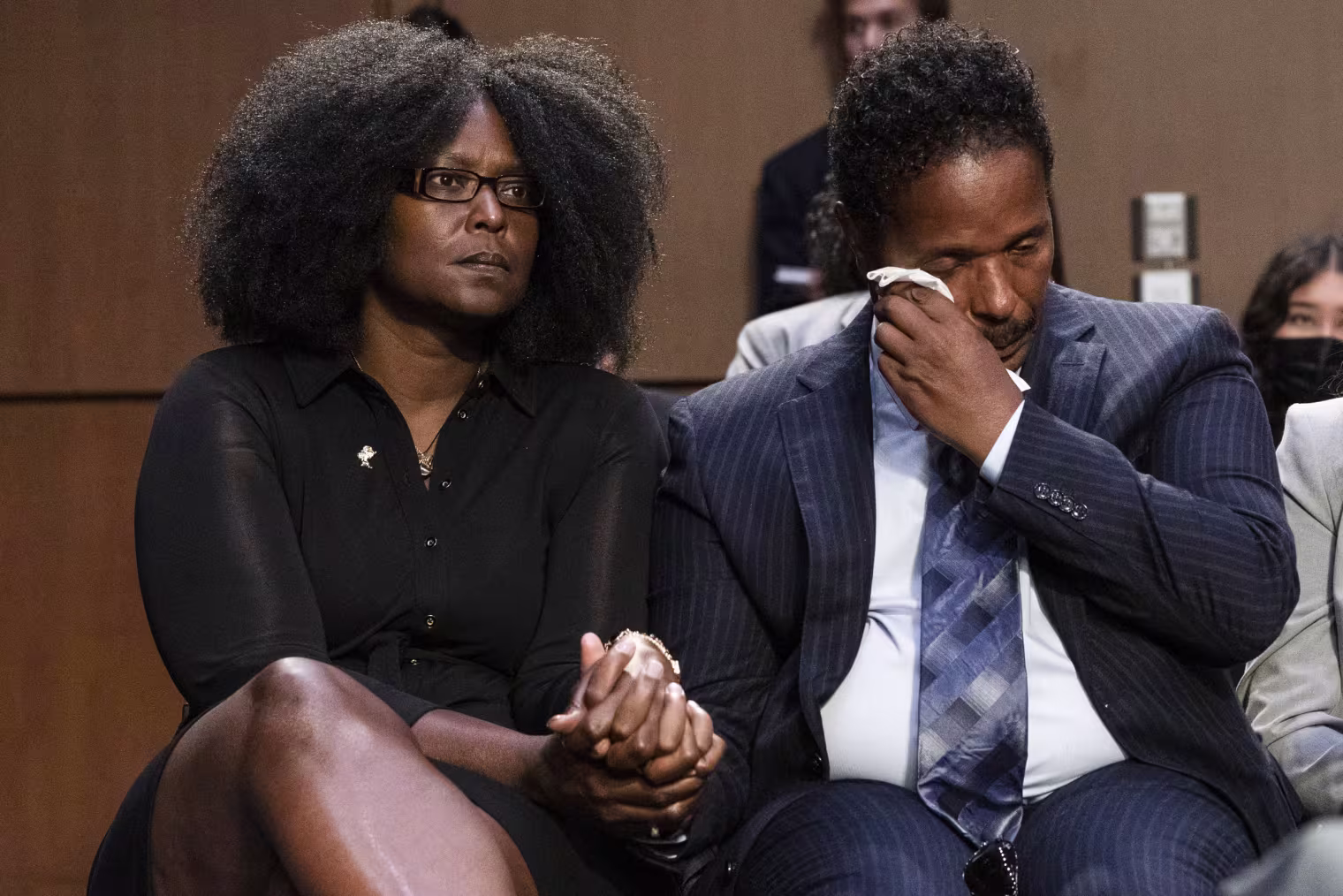 Raymond Whitfield, right, wipes his eyes as his brother Garnell Whitfield, Jr., of Buffalo, N.Y., talks about their mother Ruth Whitfield who was killed in the Buffalo Tops supermarket mass shooting during a Senate Judiciary Committee hearing on domestic terrorism on June 7, 2022. Zeneta Everhart, left, whose son Zaire Goodman, 20, was shot in the neck during the shooting and survived listens.