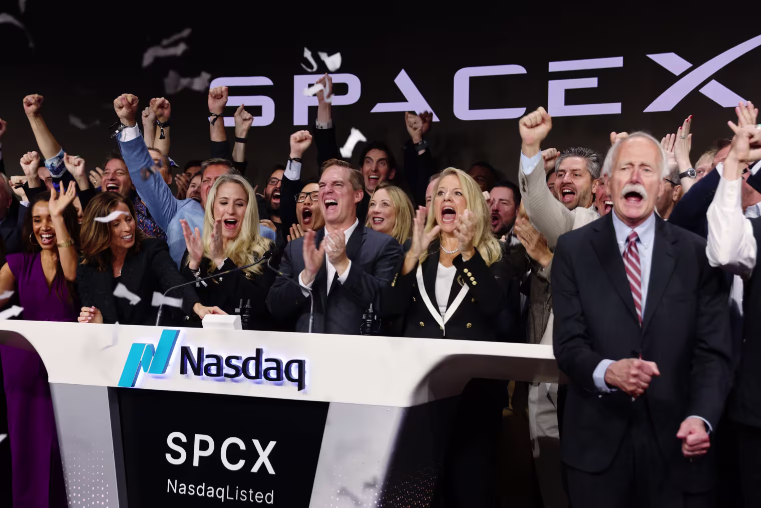 Bret Johnsen, chief financial officer of SpaceX, center, and Spacex President Gwynne Shotwell, center right, during the company's initial public offering at the Nasdaq MarketSite in New York on Friday, June 12, 2026.