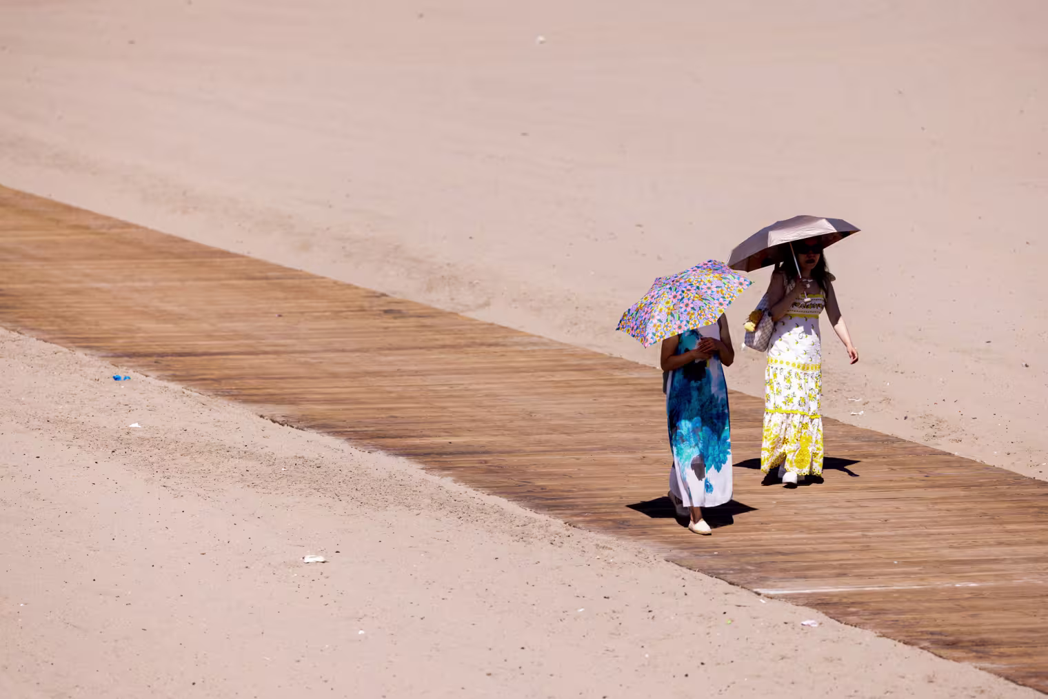 People walk with umbrellas.