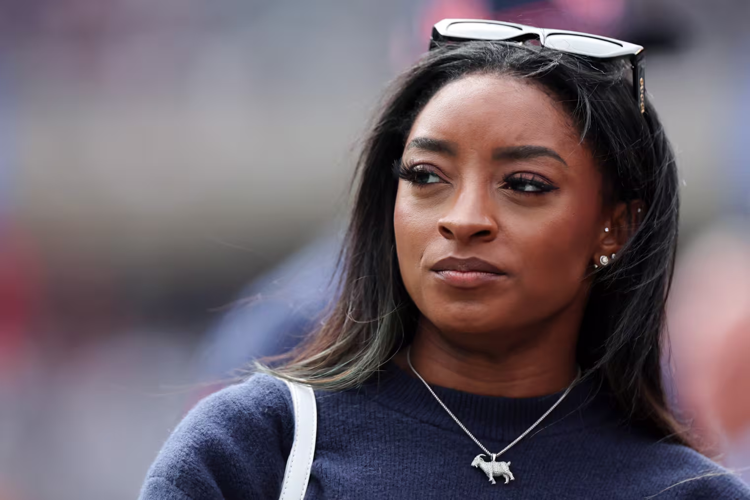 Simone Biles looks off to the side