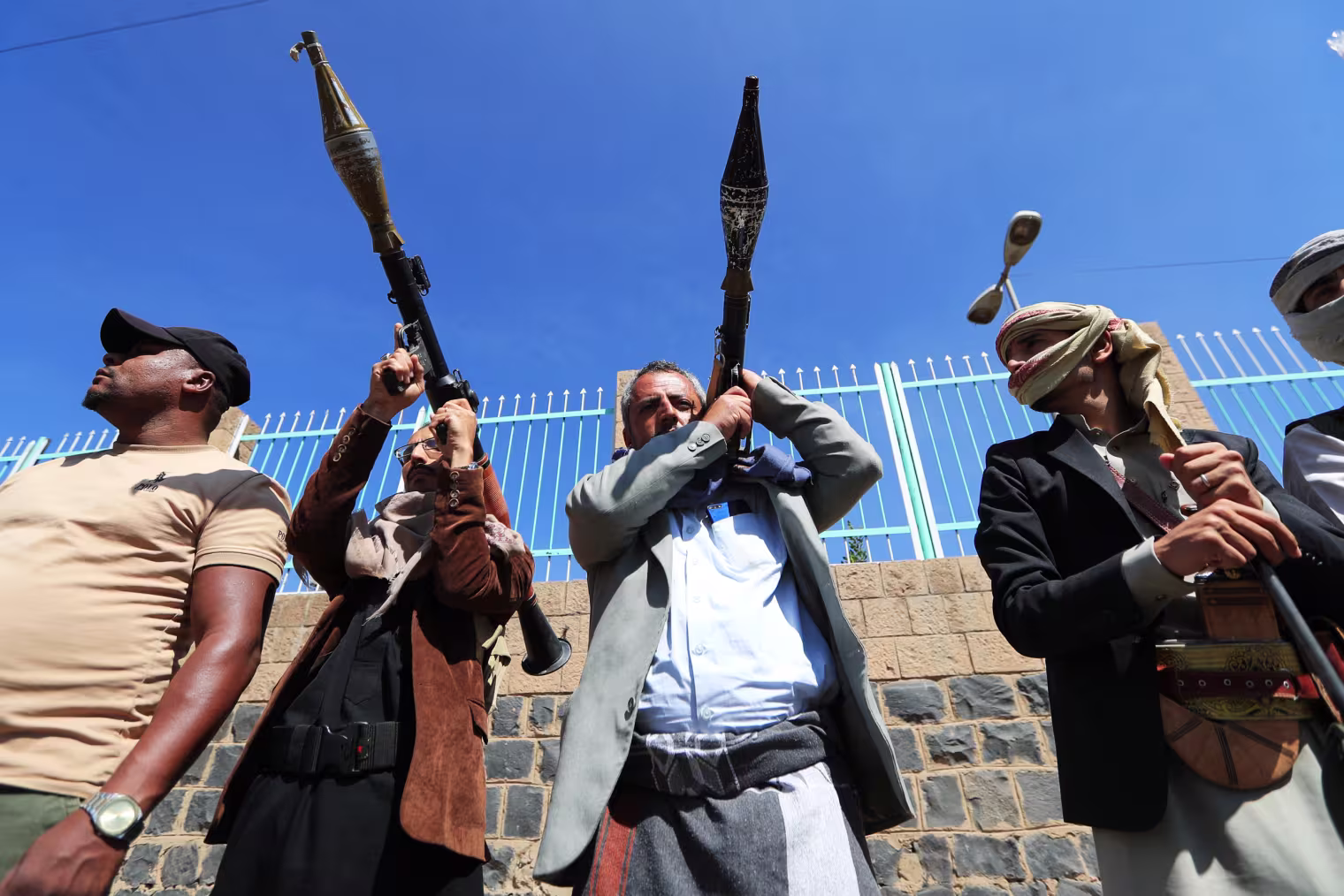 Fighters loyal to the Houthi party rally with their weapons in Yemen.