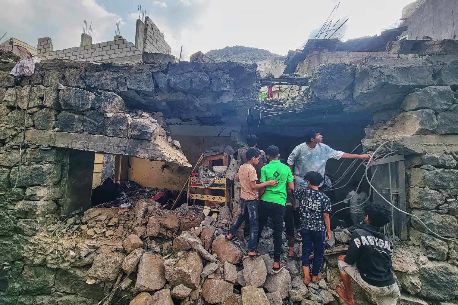 Residents walk amid debris.