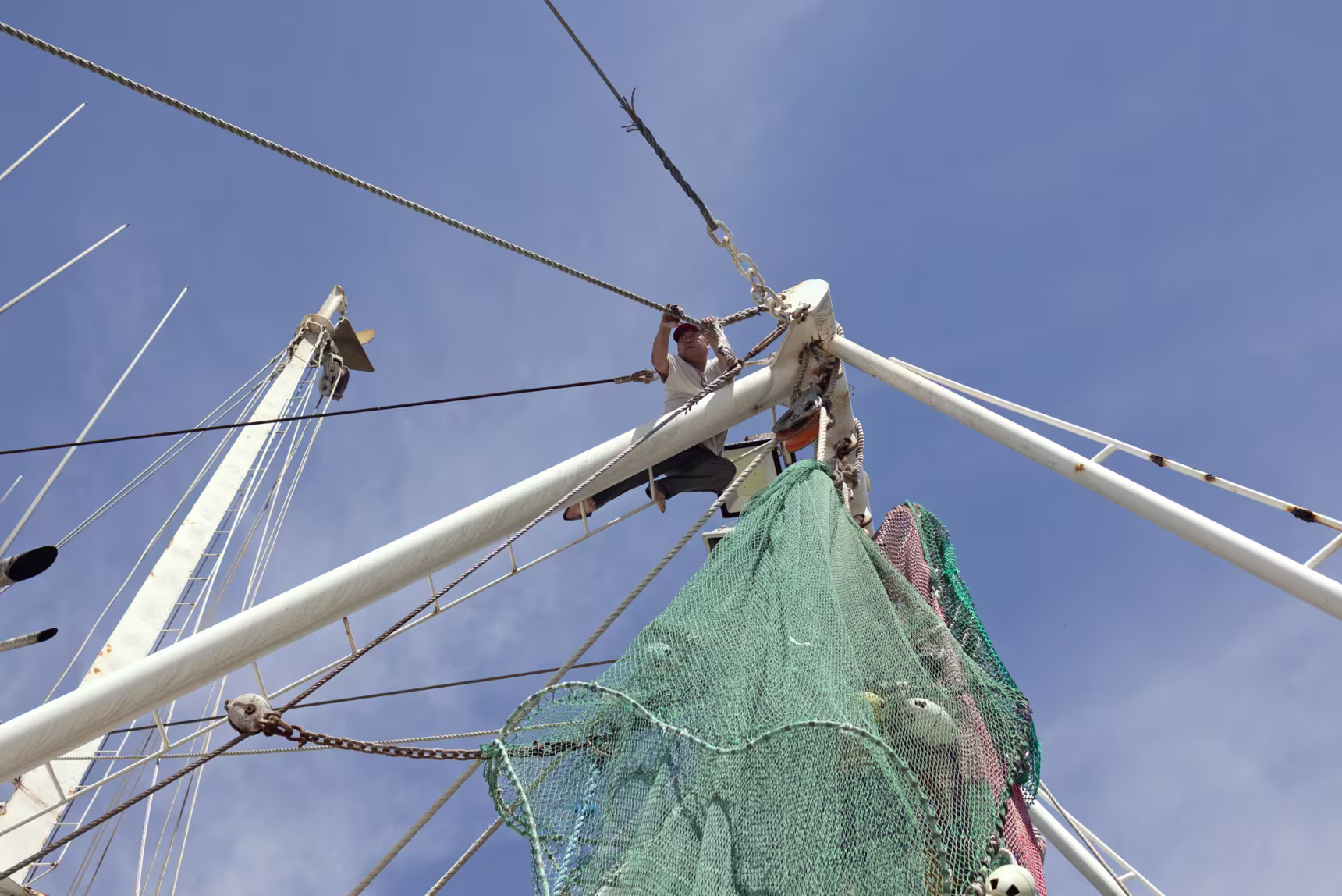 Son Phu fixes rope on a shrimp boat in Bayou La Batre last week.