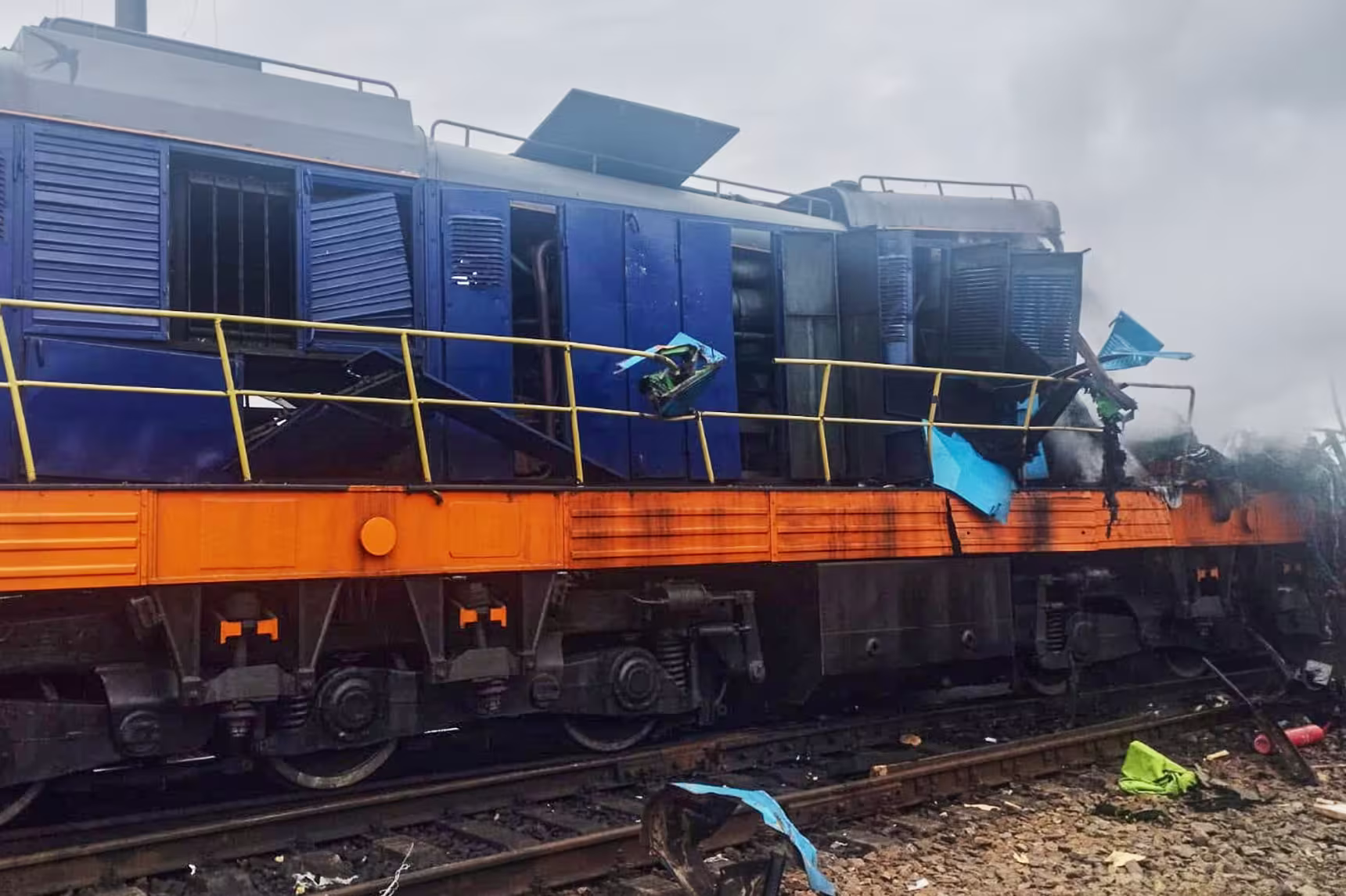 A damaged locomotive is seen on train tracks outside