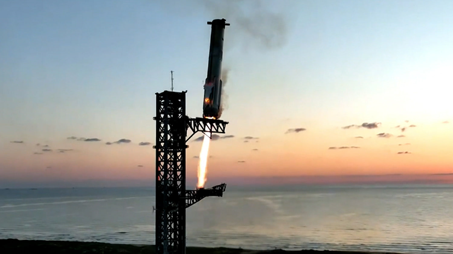 SpaceX’s Starship rocket booster successfully returns to launch tower's arms