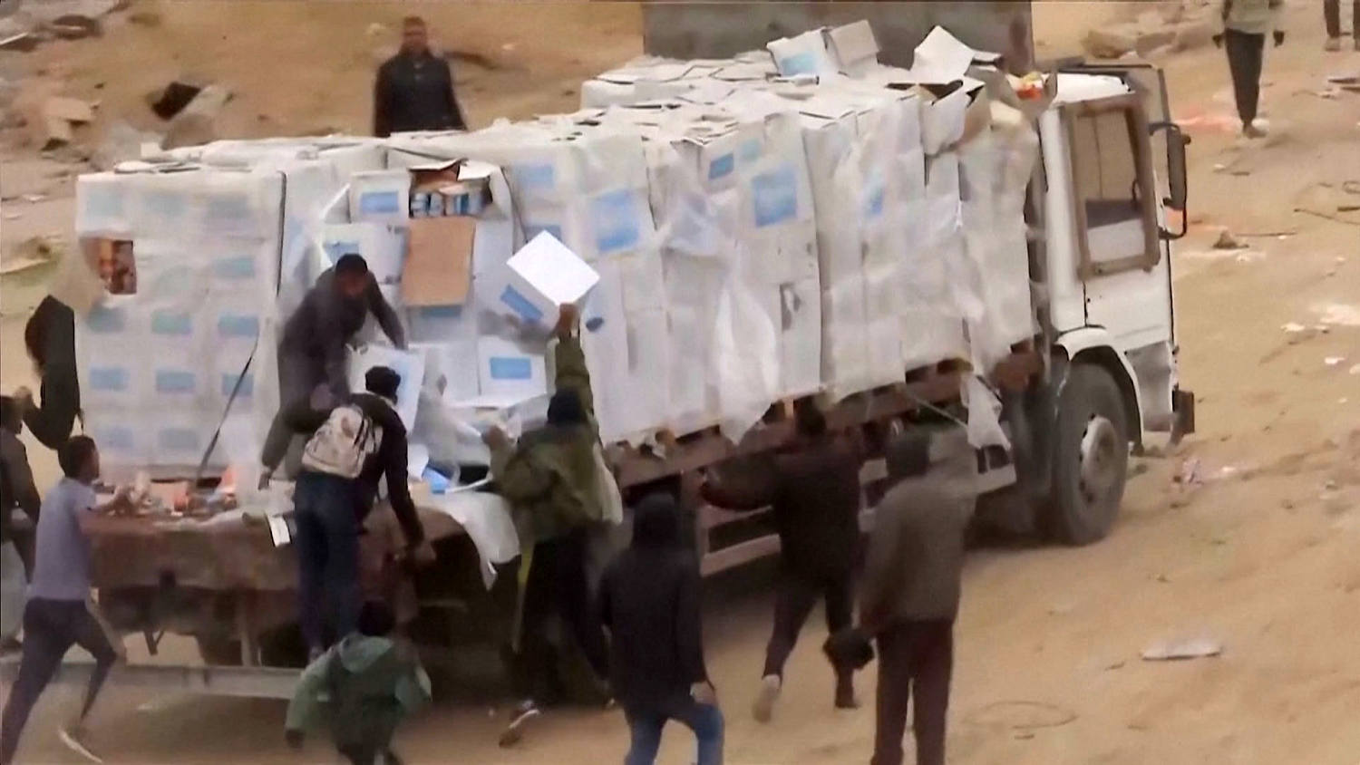 Video shows Palestinians in Gaza dragging aid supplies off the backs of trucks