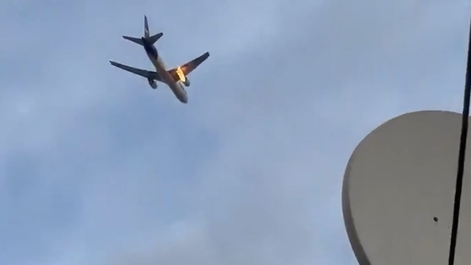 Videos show FedEx cargo plane's engine on fire mid-flight