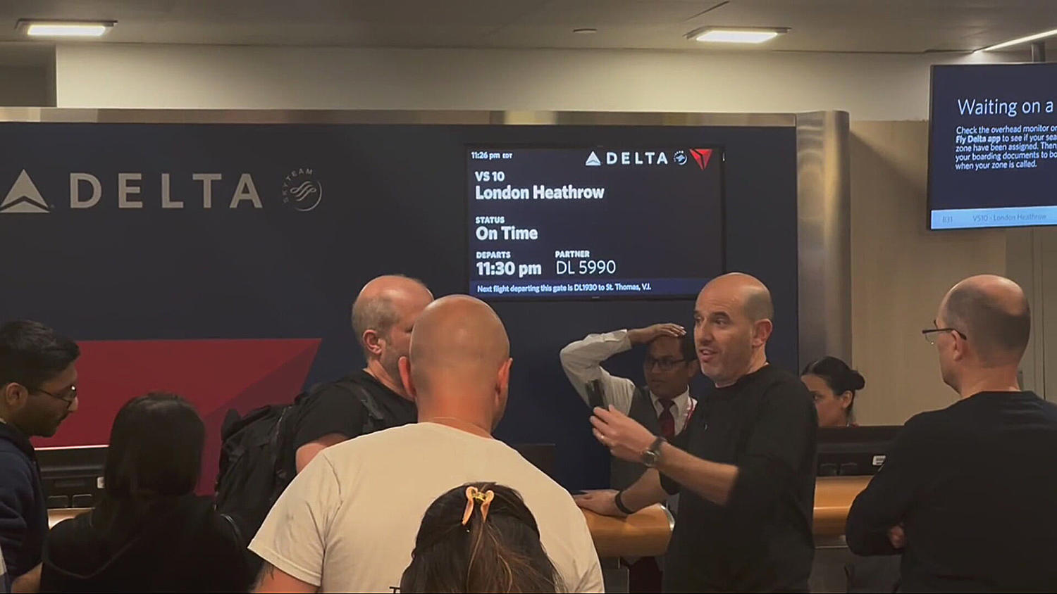 Passengers at JFK await flight information after Heathrow closure