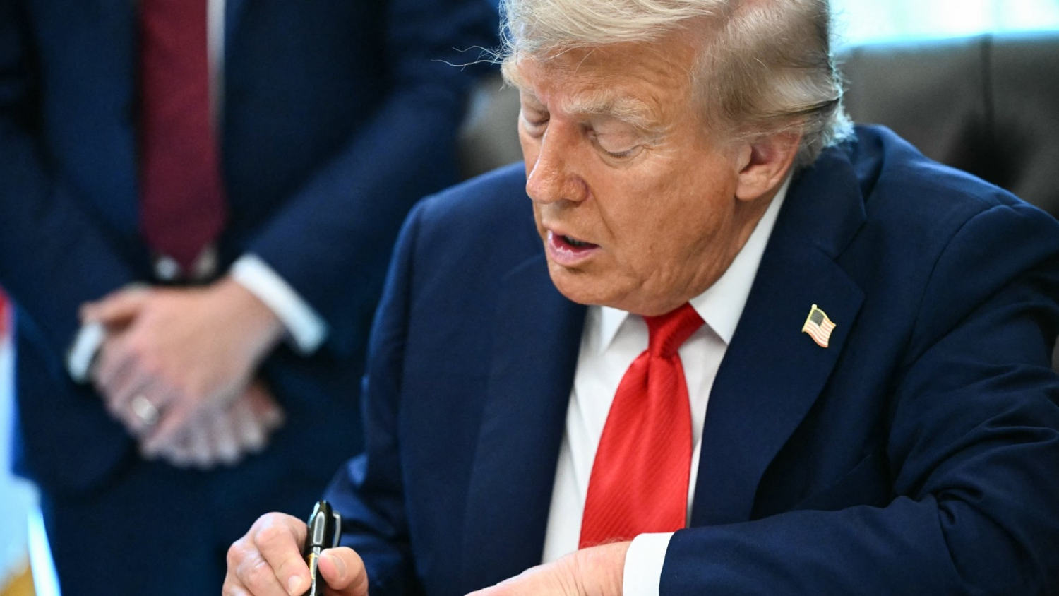 Trump signs executive orders on flag burning and eliminating cashless bail