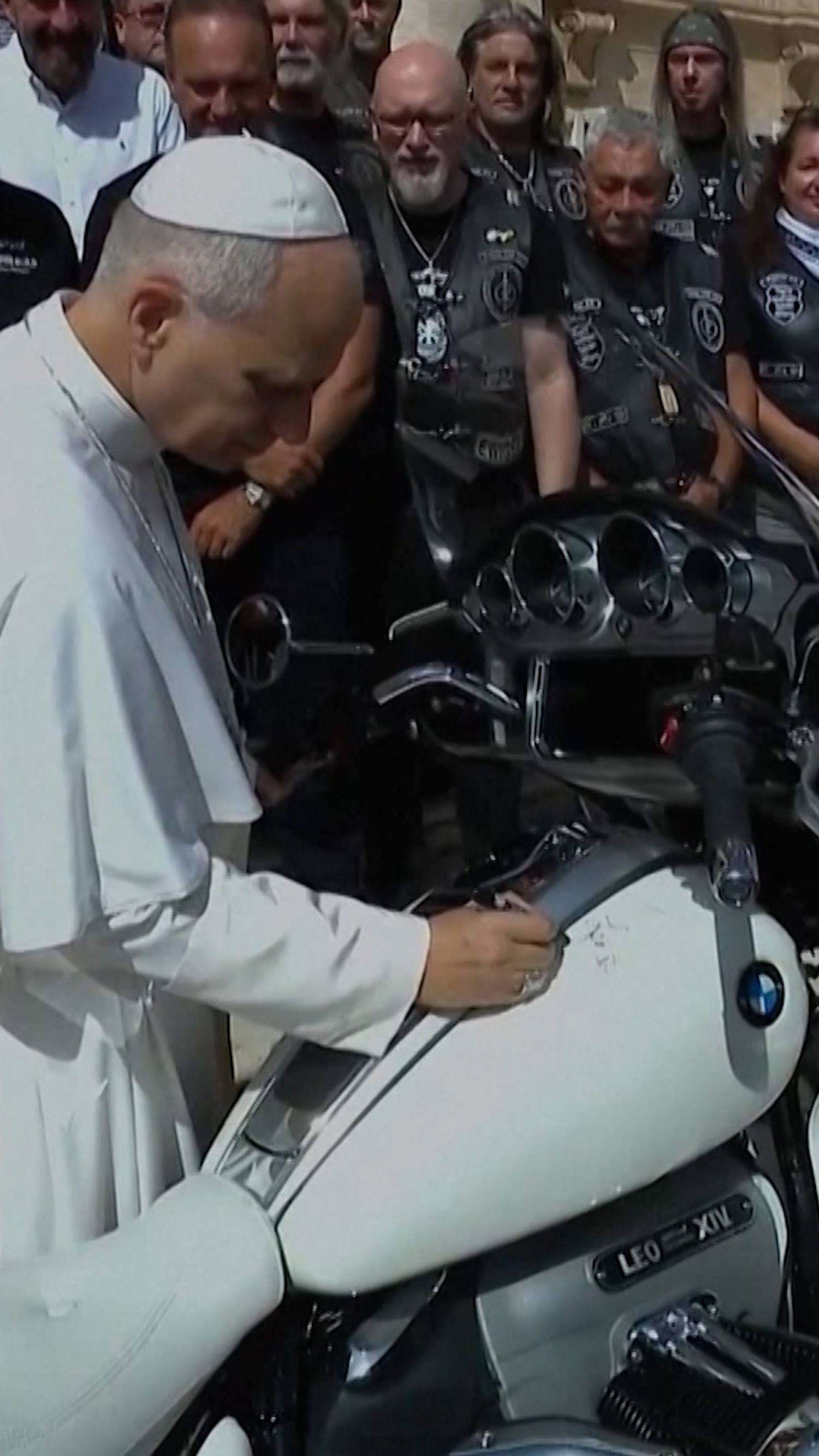 Pope Leo poses with motorbike for charity auction