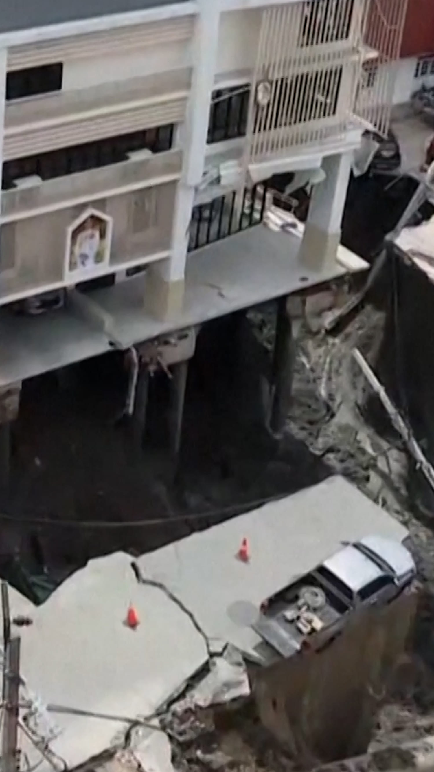 Sinkhole swallows vehicle and electrical poles