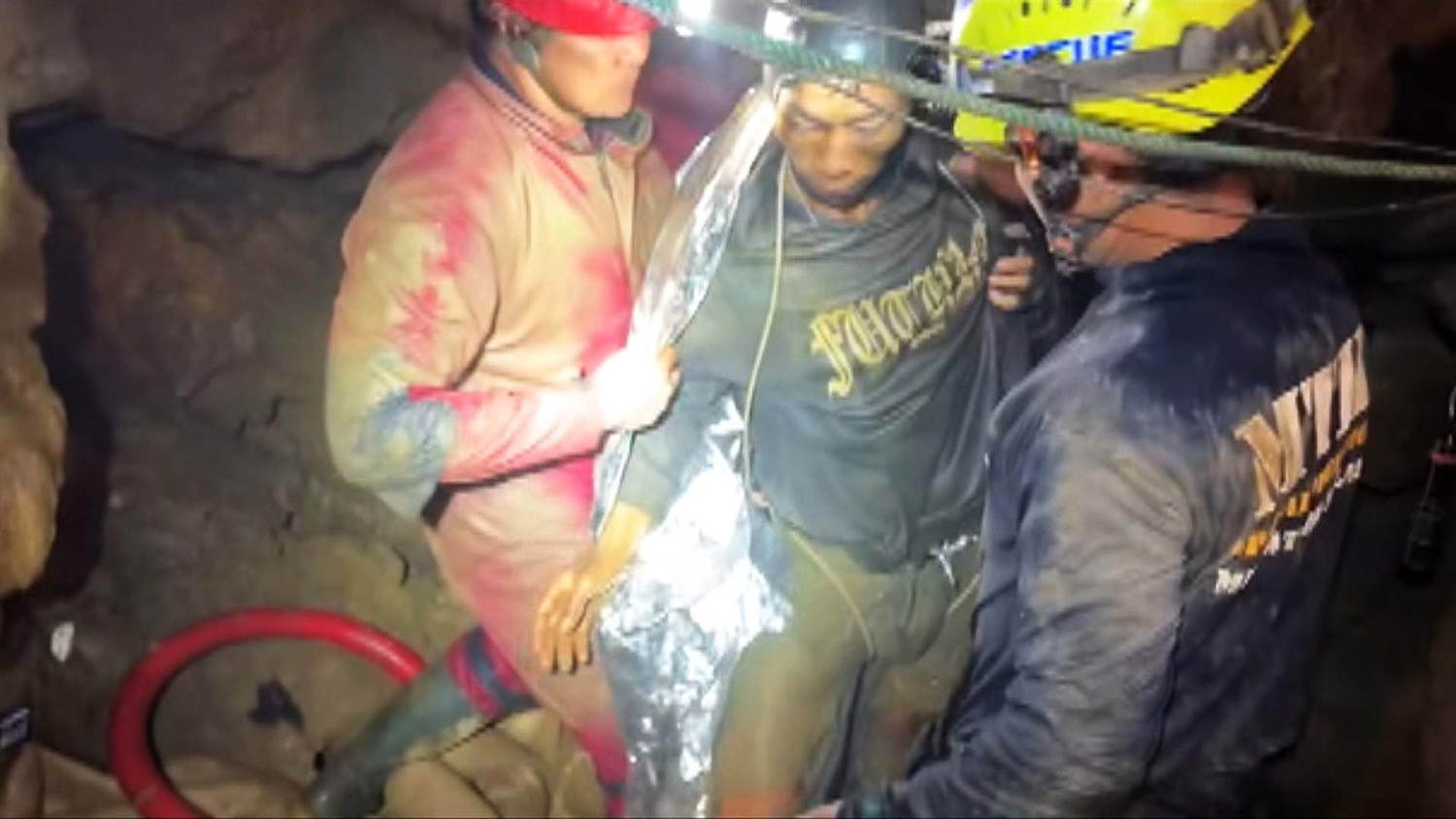 Video shows first of five men trapped in Laos cave rescued