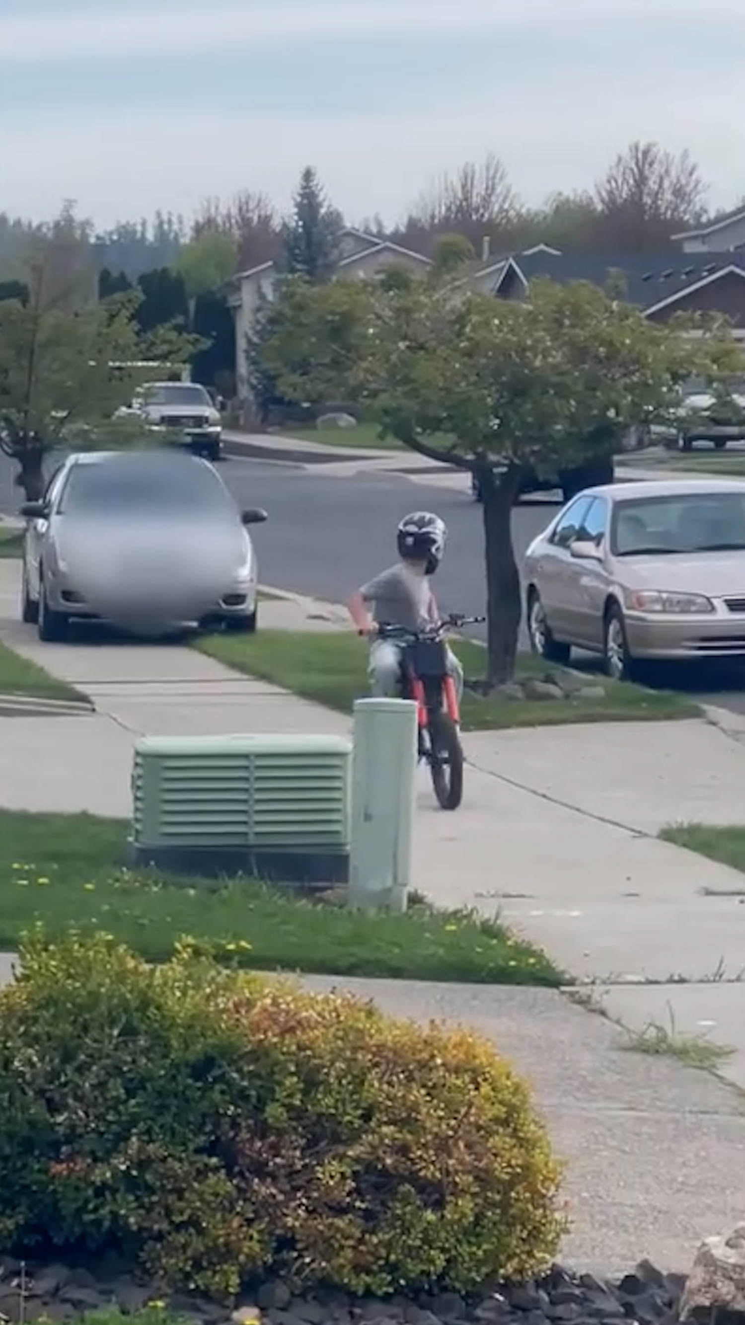 Car captured driving onto sidewalk after child on bike