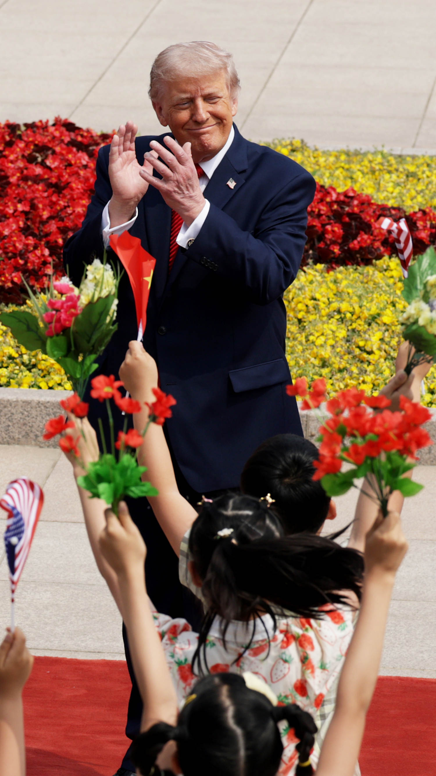 Children greet President Trump in Beijing