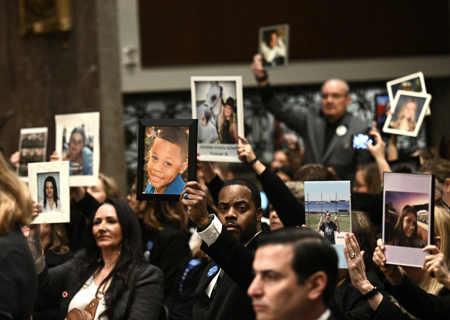 Holding photos of their deceased children, parents lobby Congress to pass online safety legislation